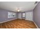 Spacious bedroom with wood floors, ceiling fan, and double closets at 1526 Leland Dr # 1525, Sun City Center, FL 33573