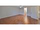Spacious bedroom with hardwood floors and hallway access at 1526 Leland Dr # 1525, Sun City Center, FL 33573