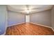 Large bedroom with wood floors, ceiling fan and access to bathroom at 1526 Leland Dr # 1525, Sun City Center, FL 33573