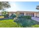 Well-maintained house with green lawn, shrubs, and a screened entryway at 1526 Leland Dr # 1525, Sun City Center, FL 33573