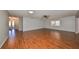 Open living room with hardwood floors and access to the entryway at 1526 Leland Dr # 1525, Sun City Center, FL 33573