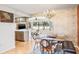 Bright dining room with a glass-top table and view into the kitchen at 153 Sunward Ave, Palm Harbor, FL 34684