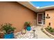 Front entry with stone accents and colorful potted plants at 153 Sunward Ave, Palm Harbor, FL 34684