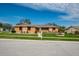 Single story home with stone accents, landscaped yard, and a two car garage at 153 Sunward Ave, Palm Harbor, FL 34684