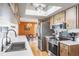 Updated kitchen with stainless steel appliances and wood cabinets at 153 Sunward Ave, Palm Harbor, FL 34684