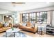 Bright living room with large windows, comfy sofas, and a coffee table at 153 Sunward Ave, Palm Harbor, FL 34684