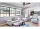 Spacious living room with white sofas, and access to a screened porch at 153 Sunward Ave, Palm Harbor, FL 34684