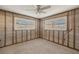 Under construction bedroom with new windows and ceiling fan at 159 Danforth Dr, Punta Gorda, FL 33980