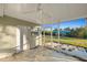 Screened porch with tiled floor and view of the backyard and canal at 159 Danforth Dr, Punta Gorda, FL 33980
