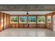 Sunroom with tiled floors, windows, and a view of the canal at 159 Danforth Dr, Punta Gorda, FL 33980