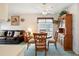 Bright dining area with wooden table and chairs near the living room and kitchen at 1606 Berwick Ct # C, Palm Harbor, FL 34684