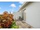 Private patio with two chairs and lush landscaping at 1606 Berwick Ct # C, Palm Harbor, FL 34684