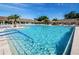 Community pool with plenty of lounge chairs at 1606 Berwick Ct # C, Palm Harbor, FL 34684