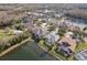 Aerial view of a lakefront community with numerous houses and lush green landscape at 16927 Melissa Ann Dr, Lutz, FL 33558