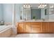 Double vanity bathroom with light wood cabinets at 16927 Melissa Ann Dr, Lutz, FL 33558