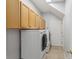 Laundry room with washer, dryer and upper cabinets at 16927 Melissa Ann Dr, Lutz, FL 33558