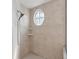 Large walk-in shower with tile surround and oval window at 16927 Melissa Ann Dr, Lutz, FL 33558