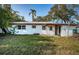 Backyard view of a white single-story house at 1820 Sutherland W Dr, Palm Harbor, FL 34683