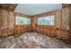 Unfinished room with exposed framing and flooring at 1820 Sutherland W Dr, Palm Harbor, FL 34683