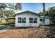 Newly painted house with blue accents at 1820 Sutherland W Dr, Palm Harbor, FL 34683