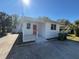 Newly renovated home with red door, front porch and driveway at 1904 W Saint Louis St, Tampa, FL 33607