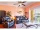 Comfortable living room with leather reclining furniture and wood floors at 21012 Picasso Ct # J205, Land O Lakes, FL 34637