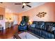 Open living space with leather furniture and a view into the kitchen at 21012 Picasso Ct # J205, Land O Lakes, FL 34637