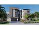 Modern three-story home with gray exterior and two-car garage at 25 Harborpointe Dr, Port Richey, FL 34668