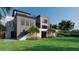 Modern home with gray exterior, large windows, and backyard at 25 Harborpointe Dr, Port Richey, FL 34668