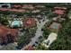 Aerial view of community with pool, tennis court, and playground at 2749 Via Cipriani # 1010B, Clearwater, FL 33764