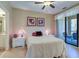 Spacious bedroom with ceiling fan and access to balcony at 2749 Via Cipriani # 1010B, Clearwater, FL 33764