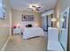 Bright bedroom with ceiling fan and private access to balcony at 2749 Via Cipriani # 1010B, Clearwater, FL 33764