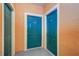 Building entrance with teal doors and storage area at 2749 Via Cipriani # 1010B, Clearwater, FL 33764