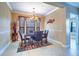 Elegant dining room with a chandelier and four chairs at 2749 Via Cipriani # 1010B, Clearwater, FL 33764