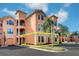 Orange building with a garage and landscaping at 2749 Via Cipriani # 1010B, Clearwater, FL 33764