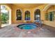 Community hot tub area with covered patio seating at 2749 Via Cipriani # 1010B, Clearwater, FL 33764