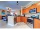 Open kitchen with stainless steel appliances and breakfast bar at 2749 Via Cipriani # 1010B, Clearwater, FL 33764