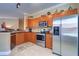 Modern kitchen with stainless steel appliances and wood cabinets at 2749 Via Cipriani # 1010B, Clearwater, FL 33764
