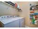 Laundry room with washer, dryer, and ample storage at 2749 Via Cipriani # 1010B, Clearwater, FL 33764