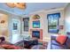 Living room with fireplace, large TV and seating area at 2749 Via Cipriani # 1010B, Clearwater, FL 33764