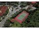 Community tennis court surrounded by lush landscaping at 2749 Via Cipriani # 1010B, Clearwater, FL 33764