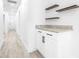 Bright hallway with white cabinets, granite countertop, and floating shelves at 2859 38Th N Ave, St Petersburg, FL 33713