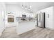 Modern kitchen with white cabinets, island, and stainless steel appliances at 2859 38Th N Ave, St Petersburg, FL 33713