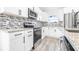 Modern kitchen with white cabinets and stainless steel appliances at 2859 38Th N Ave, St Petersburg, FL 33713