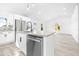 Kitchen island with sink, dishwasher, and granite countertop at 2859 38Th N Ave, St Petersburg, FL 33713
