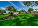 Highland Lakes Club entrance with lush landscaping and flag at 3541 Oak Lake Dr, Palm Harbor, FL 34684