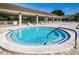 Community hot tub with surrounding lounge chairs at 3541 Oak Lake Dr, Palm Harbor, FL 34684