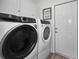 Laundry room with washer, dryer, and cabinet storage at 3541 Oak Lake Dr, Palm Harbor, FL 34684