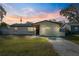 Cute brick home with a well-manicured lawn and a long driveway at 3724 15Th Se Ave, Largo, FL 33771