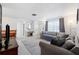 Spacious living room with gray couch and large windows at 3724 15Th Se Ave, Largo, FL 33771